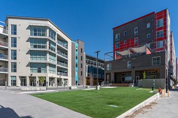 A modern building with a green lawn in front.